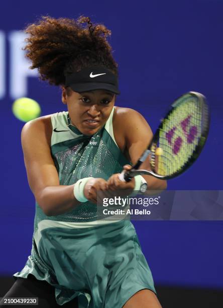 Naomi Osaka of Japan returns a shot against Elisabetta Cocciaretto of Italy during their match on Day 5 of the Miami Open at Hard Rock Stadium on...