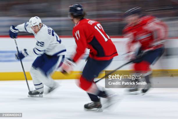 Pontus Holmberg of the Toronto Maple Leafs skates with the puck past Dylan Strome of the Washington Capitals during the first period at Capital One...