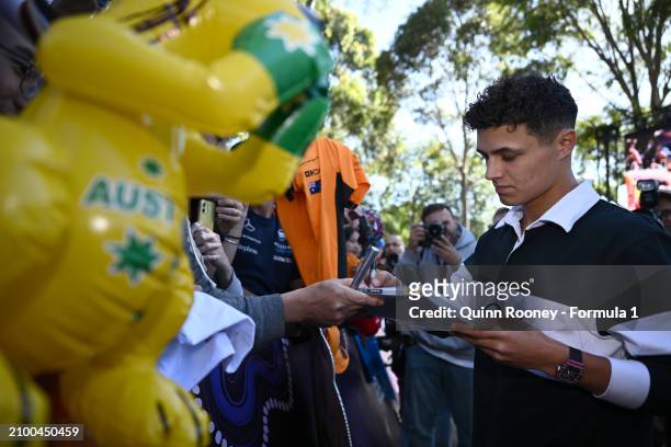 Lando Norris of Great Britain and McLaren greets fans on the Melbourne Walk as he arrives at the circuit during previews ahead of the F1 Grand Prix...