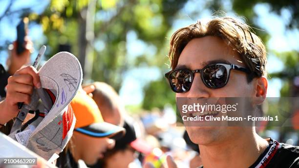 George Russell of Great Britain and Mercedes greets fans on the Melbourne Walk as he arrives at the circuit during previews ahead of the F1 Grand...