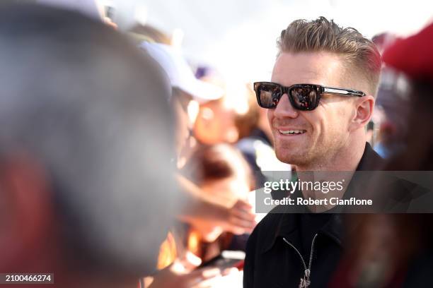 Nico Hulkenberg of Germany and Haas F1 greets fans on the Melbourne Walk as he arrives at the circuit during previews ahead of the F1 Grand Prix of...