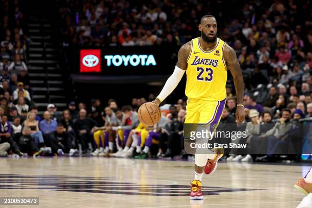 LeBron James of the Los Angeles Lakers dribbles the ball against the Sacramento Kings at Golden 1 Center on March 13, 2024 in Sacramento, California....