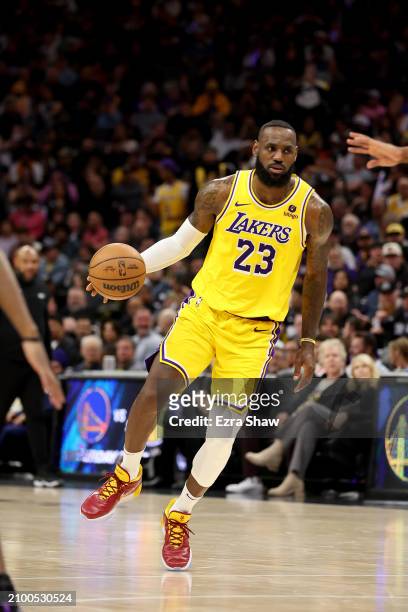 LeBron James of the Los Angeles Lakers dribbles the ball against the Sacramento Kings at Golden 1 Center on March 13, 2024 in Sacramento, California....