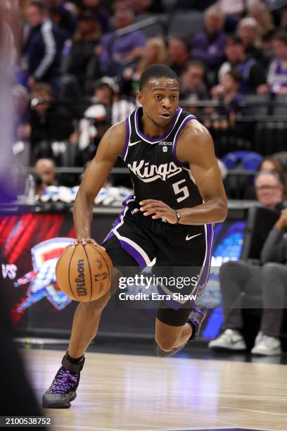 De'Aaron Fox of the Sacramento Kings dribbles the ball against the Los Angeles Lakers at Golden 1 Center on March 13, 2024 in Sacramento, California....