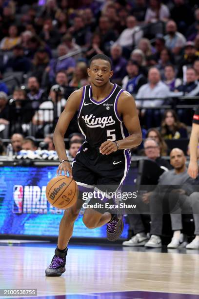 De'Aaron Fox of the Sacramento Kings dribbles the ball against the Los Angeles Lakers at Golden 1 Center on March 13, 2024 in Sacramento, California....