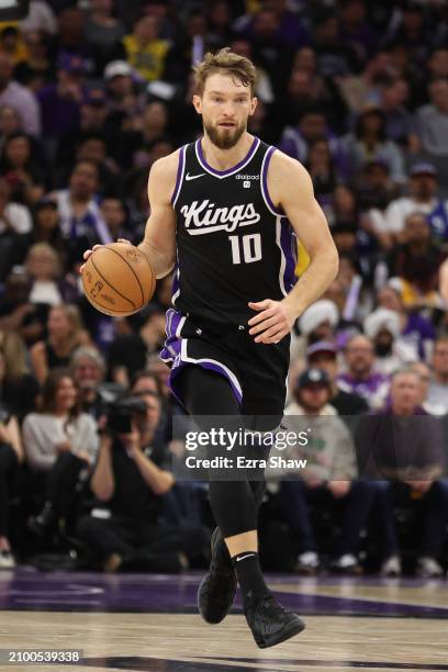 Domantas Sabonis of the Sacramento Kings dribbles the ball against the Los Angeles Lakers at Golden 1 Center on March 13, 2024 in Sacramento,...