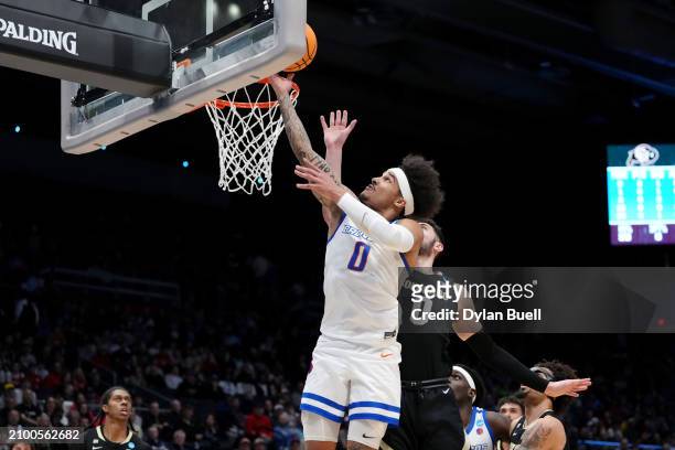 Roddie Anderson III of the Boise State Broncos shoots the ball against Luke O'Brien of the Colorado Buffaloes prior to the First Four game of the...