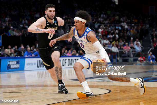 Roddie Anderson III of the Boise State Broncos drives to the basket against Luke O'Brien of the Colorado Buffaloes prior to the First Four game of...