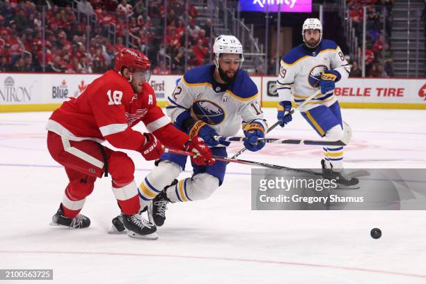 Jordan Greenway of the Buffalo Sabres battles for the puck against Andrew Copp of the Detroit Red Wings at Little Caesars Arena on March 16, 2024 in...