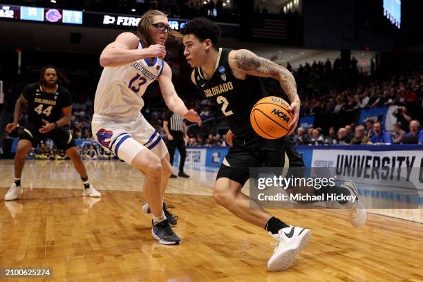 Simpson of the Colorado Buffaloes drives to the basket against Andrew Meadow of the Boise State Broncos during the first half in the First Four game...