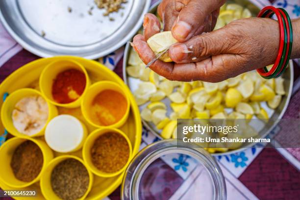 pickle : hands slicing and preparing lemon pickle - i was turning into a vegetable stock pictures, royalty-free photos & images