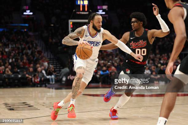 Amir Coffey of the Los Angeles Clippers drives to the basket against Scoot Henderson of the Portland Trail Blazers during the first quarter at Moda...