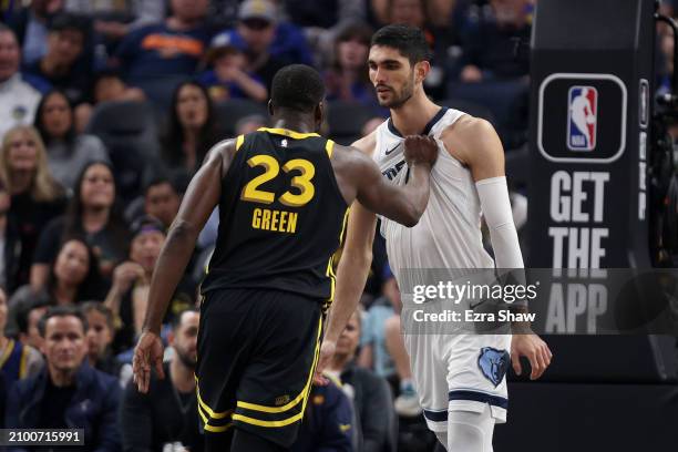Draymond Green of the Golden State Warriors pulls the jersey of Santi Aldama of the Memphis Grizzlies in the first half at Chase Center on March 20,...