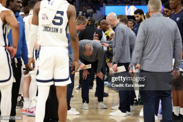 Memphis Grizzlies head coach Taylor Jenkins holds his knee after an altercation in their game against the Golden State Warriors in the first half at...