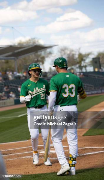 Zack Gelof of the Oakland Athletics is congratulated by JJ Bleday after hitting a home run during a spring training game against the San Francisco...