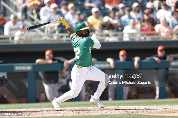 Miguel Andujar of the Oakland Athletics bats during a spring training game against the San Francisco Giants at HoHoKam Stadium on February 28, 2024...