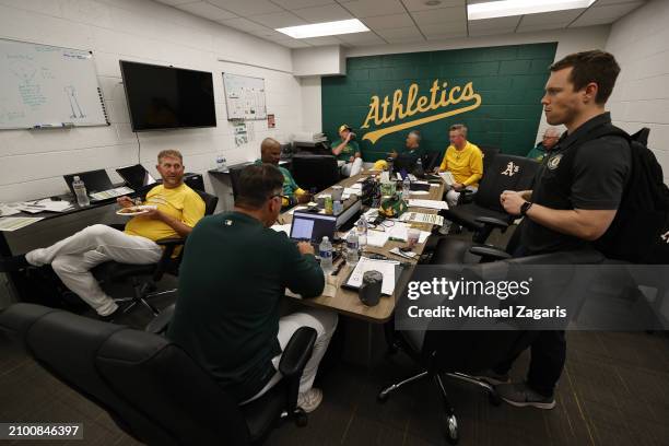 Director of Baseball Development Pike Goldschmidt of the Oakland Athletics in the clubhouse with coaches before a spring training game against the...