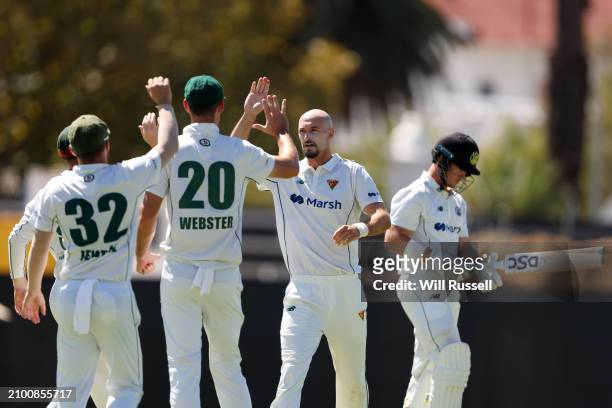 Gabe Bell of Tasmania celebrates the wicket of D'Arcy Short of Western Australia during day one of the Sheffield Shield Final match between Western...
