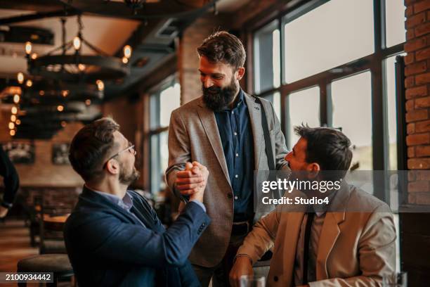 business associates meeting at a bar - business finance and industry stock pictures, royalty-free photos & images