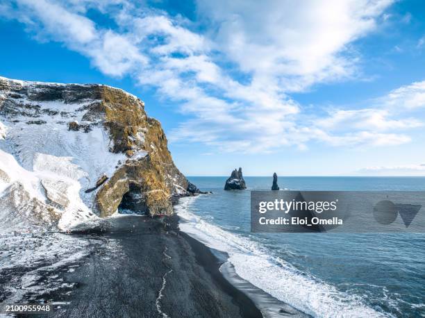 aerial view of the black volcanic beach in iceland and troll toes rocks in the sea. - iceland stockfoto's en -beelden