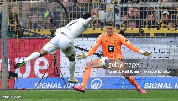 Goalkeeper Alexander Meyer of Borussia Dortmund makes a save against Omar Marmoush of Eintracht Frankfurt during the Bundesliga match between...