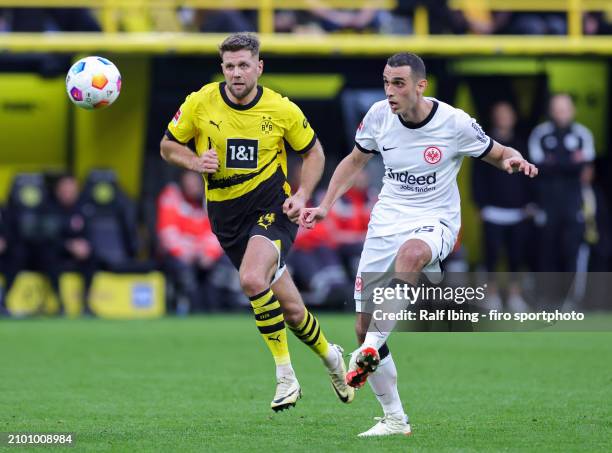 Niclas Füllkrug of Borussia Dortmund and Ellyes Skhiri of Eintracht Frankfurt compete for the ball during the Bundesliga match between Borussia...