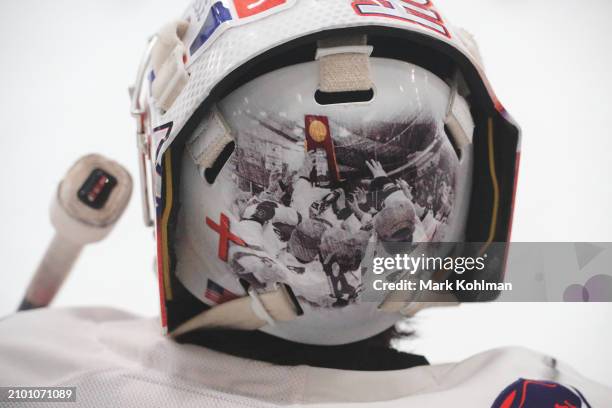 Damon Beaver's of the Hobart Statesmen helmet graphic depicts raising the championship trophy during the Division III Men's Ice Hockey Championship...