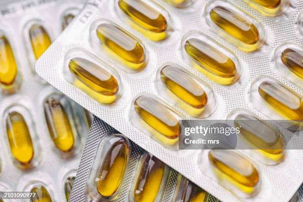 omega-3 fatty acids pills in blister packs - cod liver oil stock pictures, royalty-free photos & images