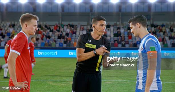 referee showing toss coin to team captions - referee shirt stock pictures, royalty-free photos & images