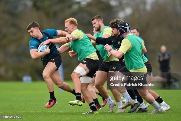 Cameron Redpath of Bath Rugby with the ball fends team-mate Miles Reid during a Bath Rugby training session at Farleigh House on March 20, 2024 in...