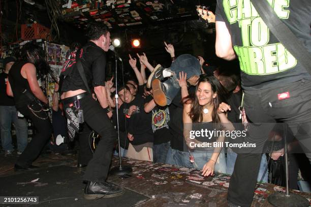 Corey Beaulieu and Matt Heafy of the heavy metal band Trivium perform while audience member stage dives at club CBGB's on March 9th 2005 in New York...