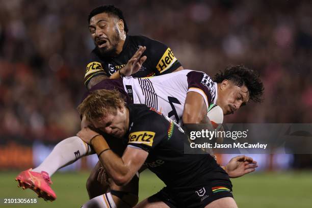 Kotoni Staggs of the Broncos is tackled by Moses Leota of the Panthers during the round three NRL match between Penrith Panthers and Brisbane Broncos...