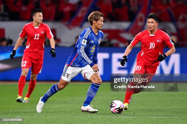 Hidemasa Morita of Japan runs with the ball whilst under pressure from Han Kwang Song of North Korea during the FIFA World Cup Asian 2nd qualifier...