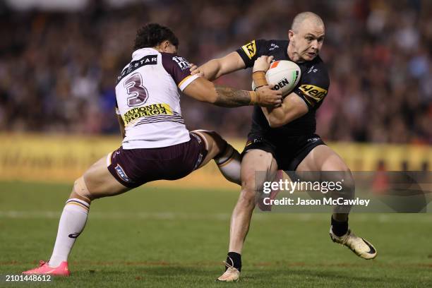 Dylan Edwards of the Panthers is tackled by Kotoni Staggs of the Broncos during the round three NRL match between Penrith Panthers and Brisbane...