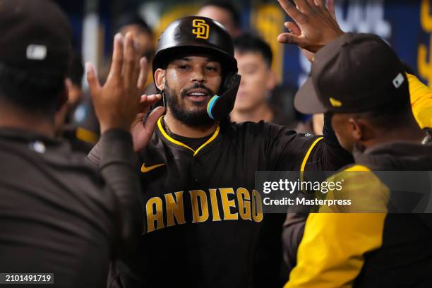 Luis Campusano of the San Diego Padres celebrates with teammates after scoring a run by a RBI single of Tyler Wade in the 1st inningduring the 2024...