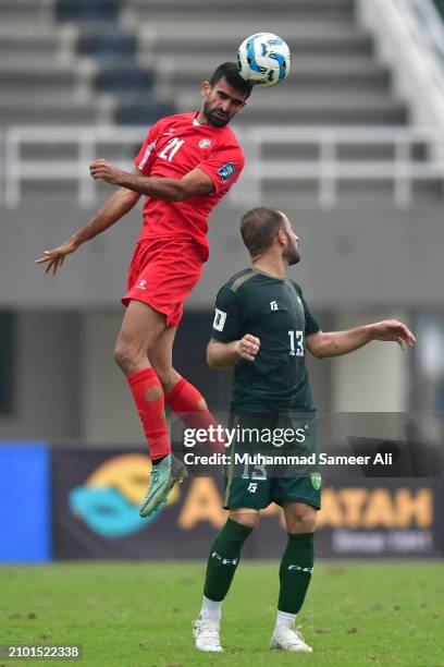 Nizar Mahmoud of team Jordan jumps in the air to save the ball from Fareed Ullah of Pakistan during the 2026 FIFA World Cup Qualifiers second round...