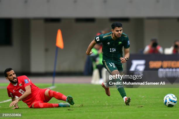 Abdul Samad of Pakistan takes the ball from Mahmoud Nayef of Jordan during the 2026 FIFA World Cup Qualifiers second round Group G match between...
