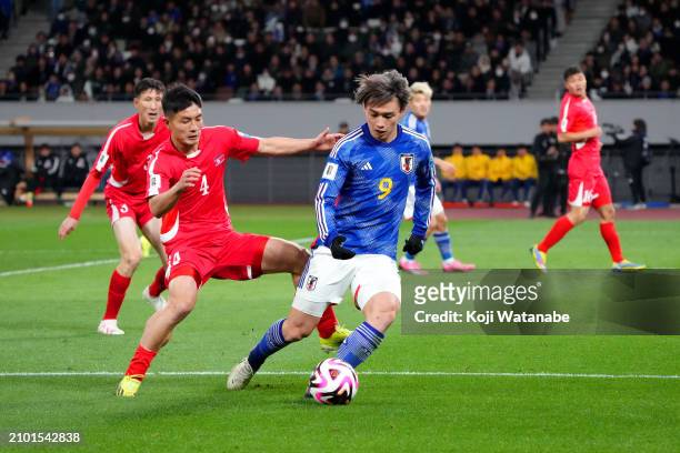 Ayase Ueda of Japan controls the ball whilst under pressure from Kim Pom Hyok of North Korea during the FIFA World Cup Asian 2nd qualifier Group B...