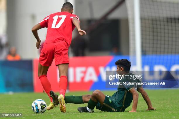 Muhammad Adeel from Pakistan on floor tries to tackle Salem Mahmoud of Jordan during the 2026 FIFA World Cup Qualifiers second round Group G match...