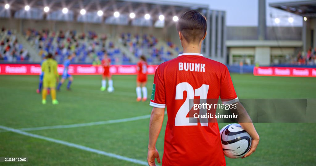 Football player standing on football pitch