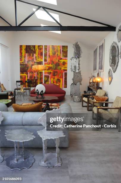 An outside view on the home-studio laboratory of the French artist Hélène de Saint-Lager with tables, chairs, mirrors, light fixtures, carpet in...