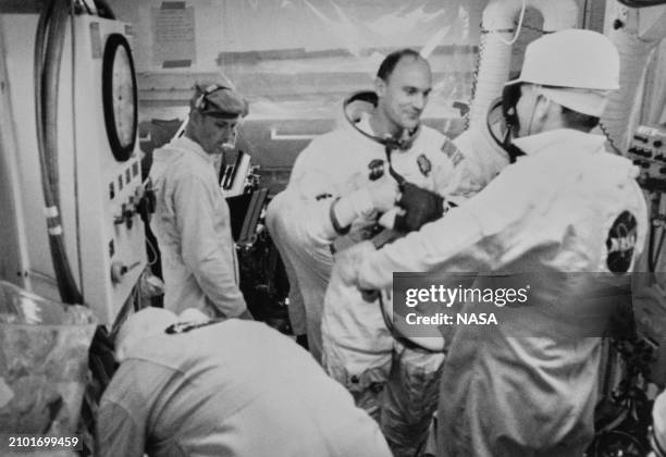 American astronaut Ken Mattingly, Apollo 13 Command Module pilot, exits the spacecraft and enters the white room, surrounded by NASA technicians...