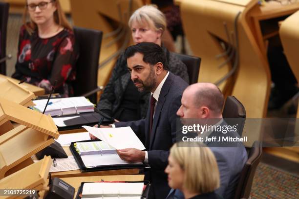 Scottish First Minister Humza Yousaf reacts as he answers questions during First Minister's Questions at Scottish Parliament at Scottish Parliament...