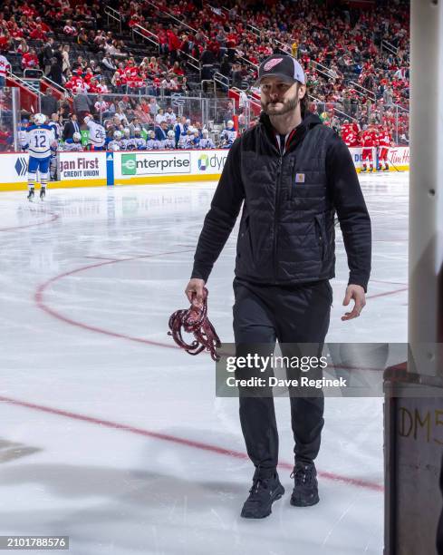 The Detroit Red Wings Zamboni driver Dave Jones carries an octopus that was tossed to the ice during the first period of the game against the Buffalo...