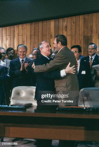 Soviet leader Mikhail Gorbachev embracing Cuban President Fidel Castro after signing a treaty at the National Assembly of People's Power in Havana,...