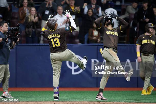 Manny Machado of the San Diego Padres celebrates with Fernando Tatis Jr. #23 after hitting a three run home run in the 9th inning during the 2024...