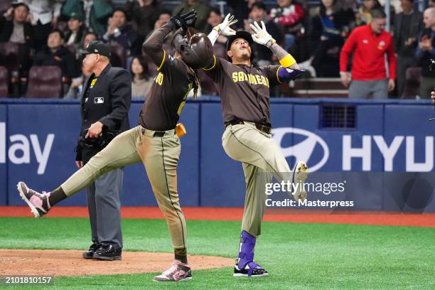 Manny Machado of the San Diego Padres celebrates with Fernando Tatis Jr. #23 after hitting a three run home run in the 9th inning during the 2024...