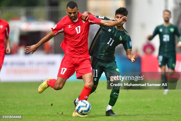 Salem Mahmoud of Jordan tries to kick the ball while Muhammad Adeel of Pakistan prevents him during the 2026 FIFA World Cup Qualifiers second round...