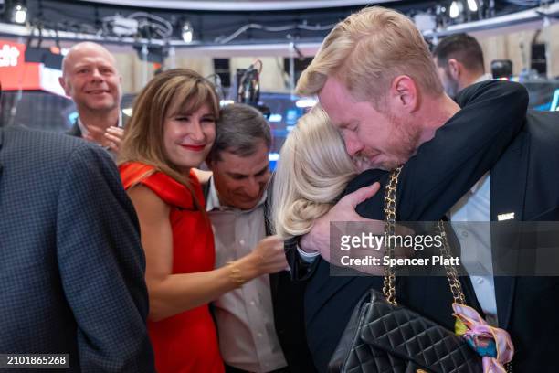 Reddit CEO Steve Huffman hugs employees and family on the floor of the New York Stock Exchange as it prepares for Reddit's initial public offering on...