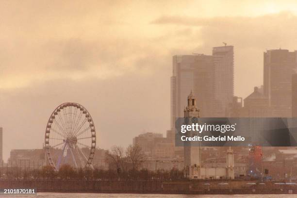 view of montreal skyline by st. lawrence river during sunset - old montreal stock pictures, royalty-free photos & images